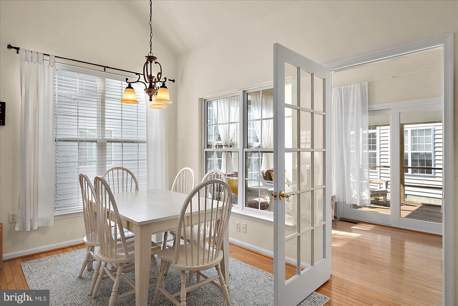 2 Audubon Circle Berlin, MD 21811 - Photo 19 of 71 a view of a dining room and livingroom with furniture wooden floor a chandelier