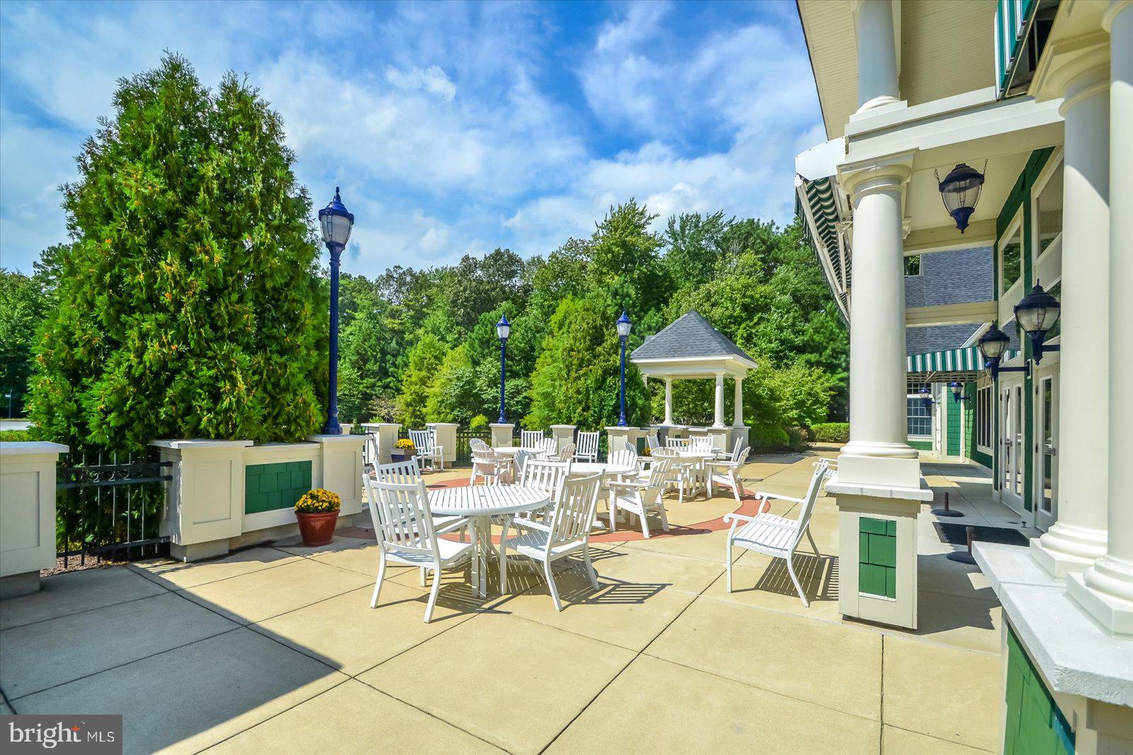 2 Audubon Circle Berlin, MD 21811 - Photo 63 of 71 a view of a patio with a table and chairs under an umbrella with a fire pit