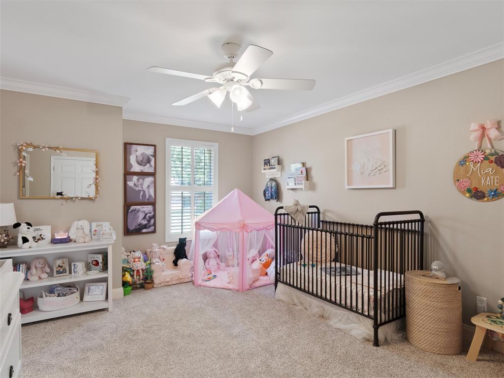 1103 Marigold Lane Longview, TX 75604 - Photo 25 of 34 a bedroom with a bed and a chandelier