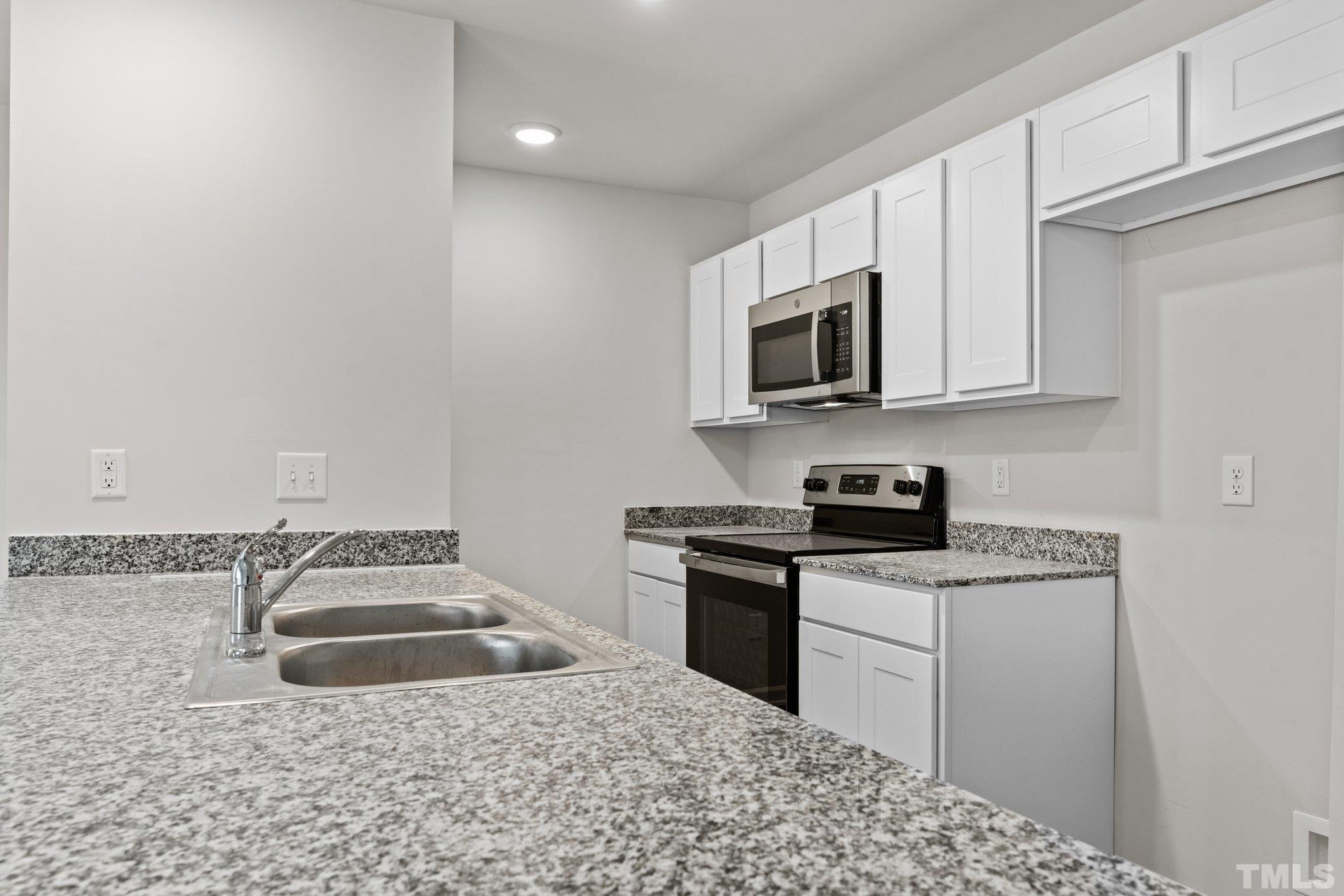 96 Somerset Drive Roxboro, NC 27573 - Photo 13 of 29 a kitchen with a sink stove and microwave