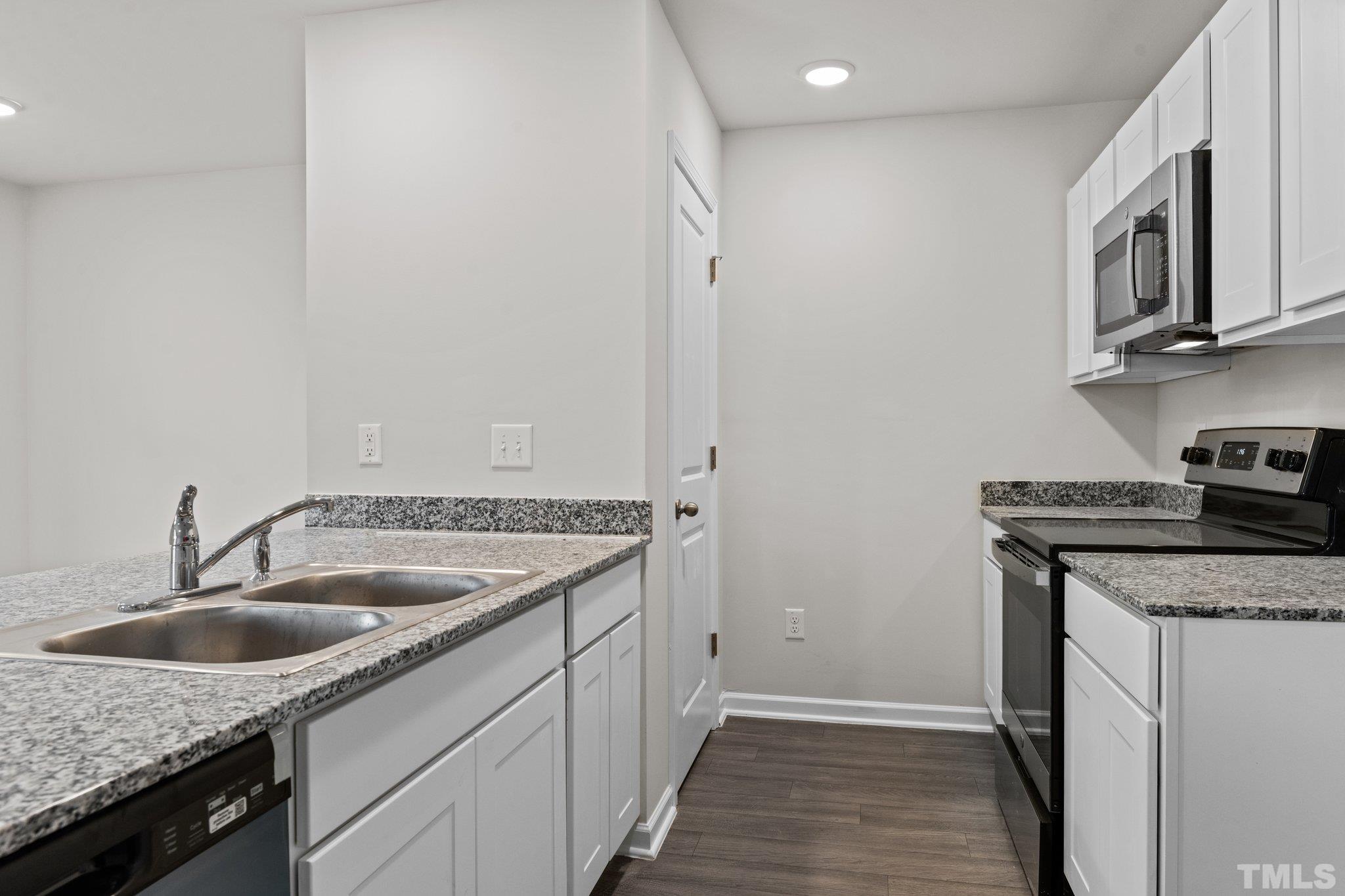 96 Somerset Drive Roxboro, NC 27573 - Photo 14 of 29 a kitchen with stainless steel appliances granite countertop a sink stove and cabinets