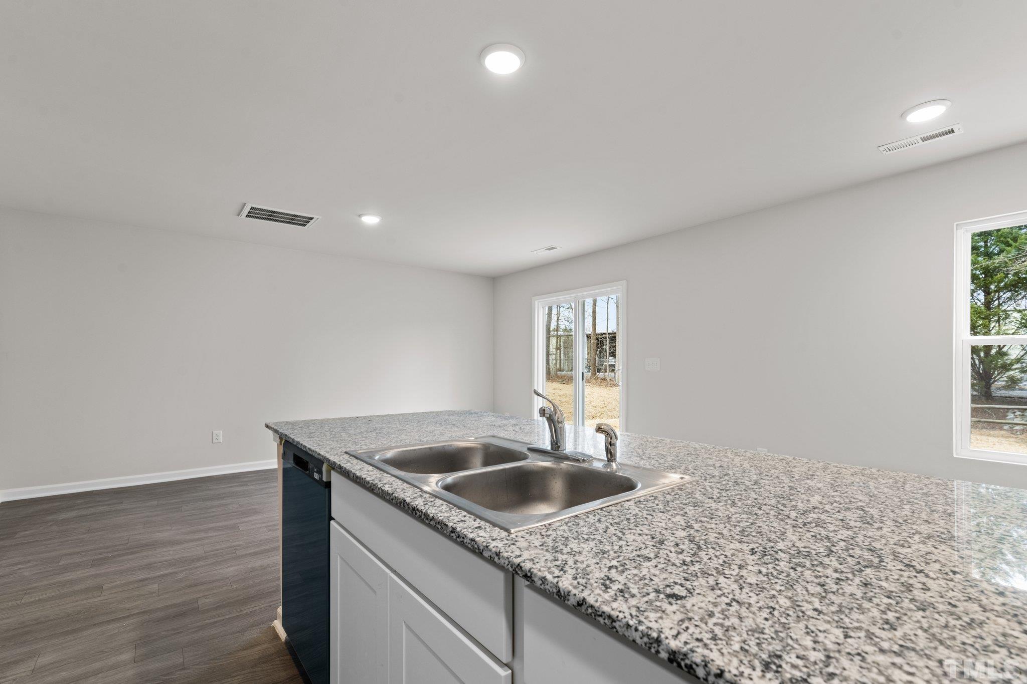 96 Somerset Drive Roxboro, NC 27573 - Photo 15 of 29 a kitchen with sink cabinets and window