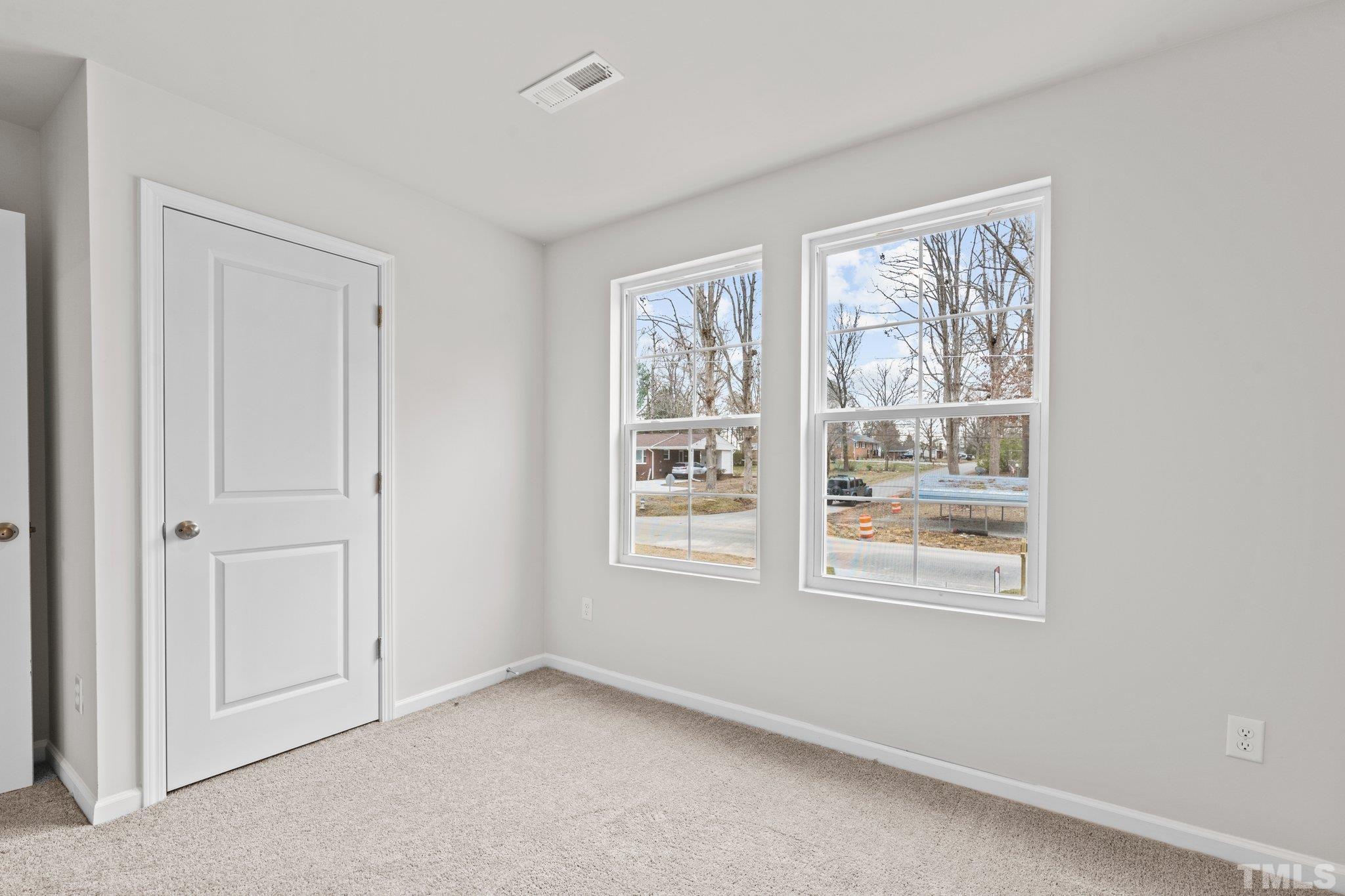 96 Somerset Drive Roxboro, NC 27573 - Photo 17 of 29 an empty room with windows