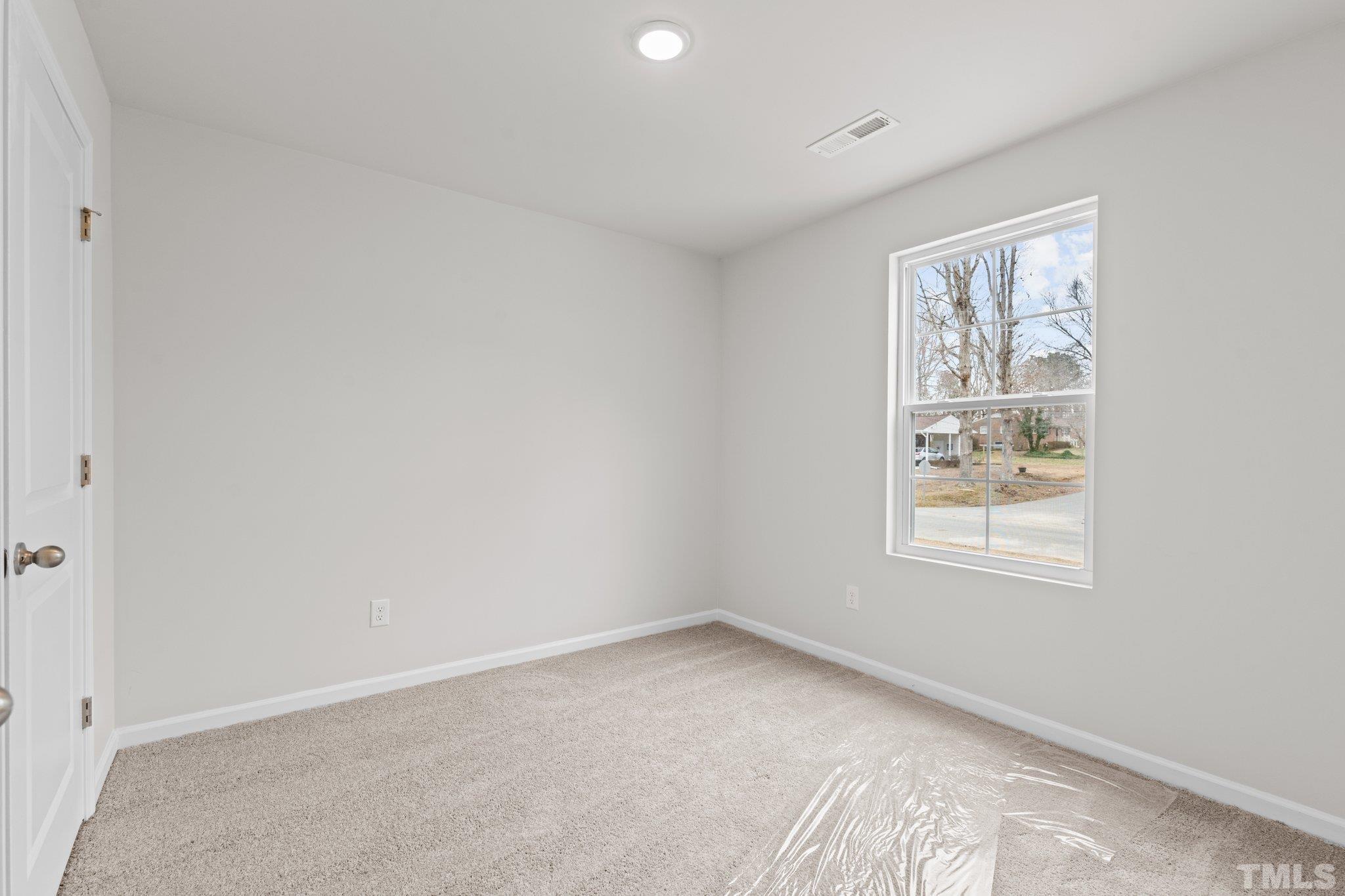 96 Somerset Drive Roxboro, NC 27573 - Photo 18 of 29 an empty room with a window