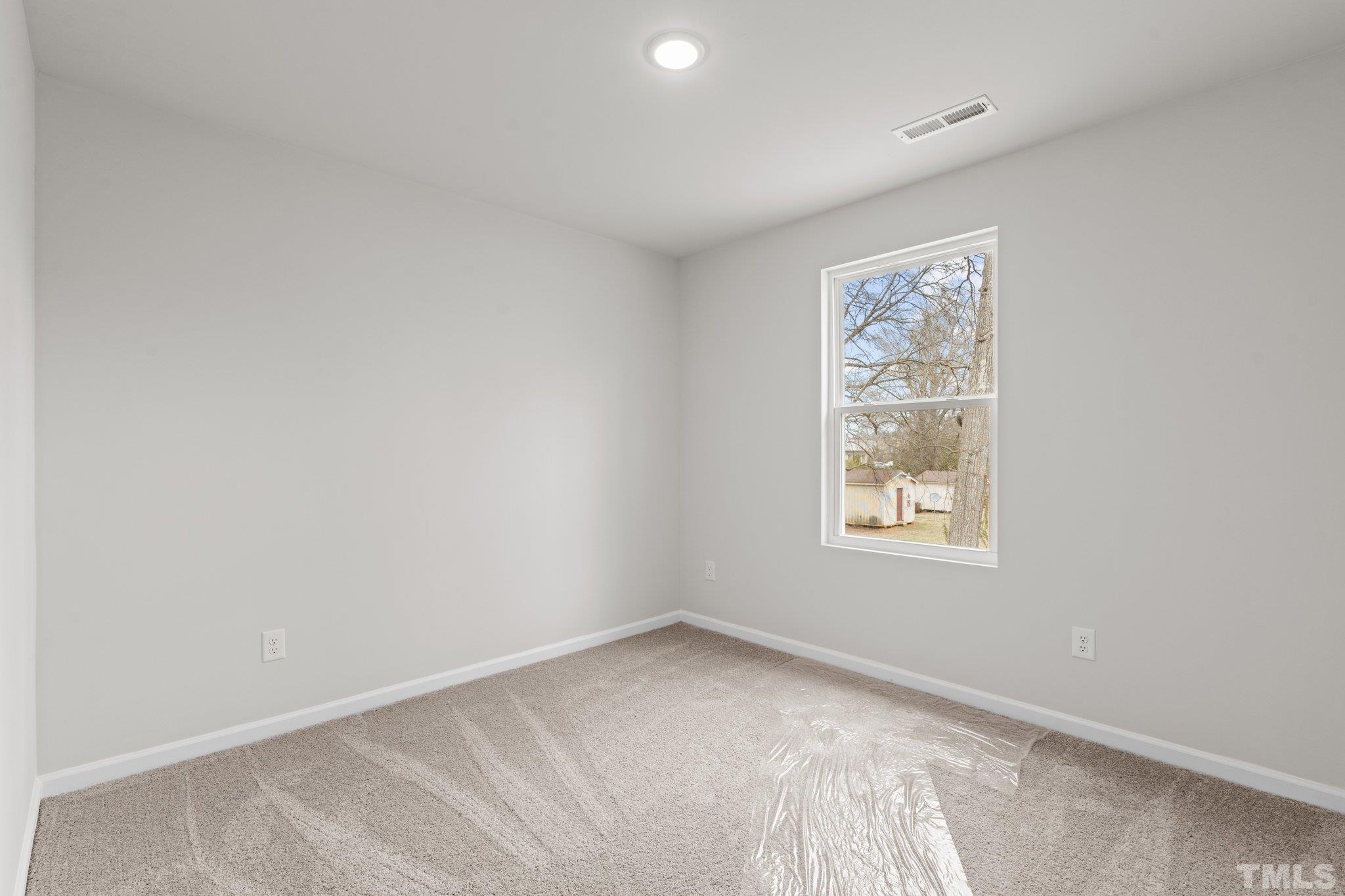 96 Somerset Drive Roxboro, NC 27573 - Photo 19 of 29 an empty room with a window
