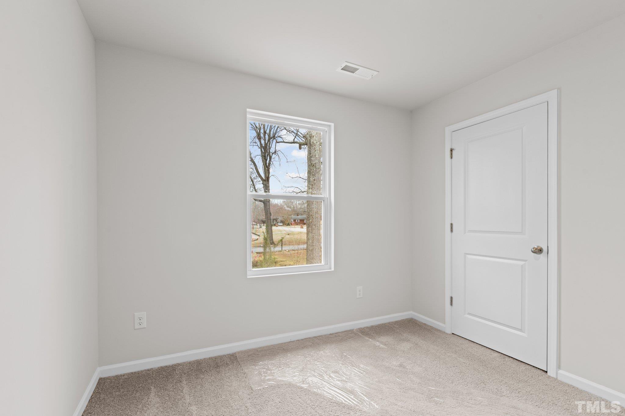 96 Somerset Drive Roxboro, NC 27573 - Photo 20 of 29 an empty room with windows