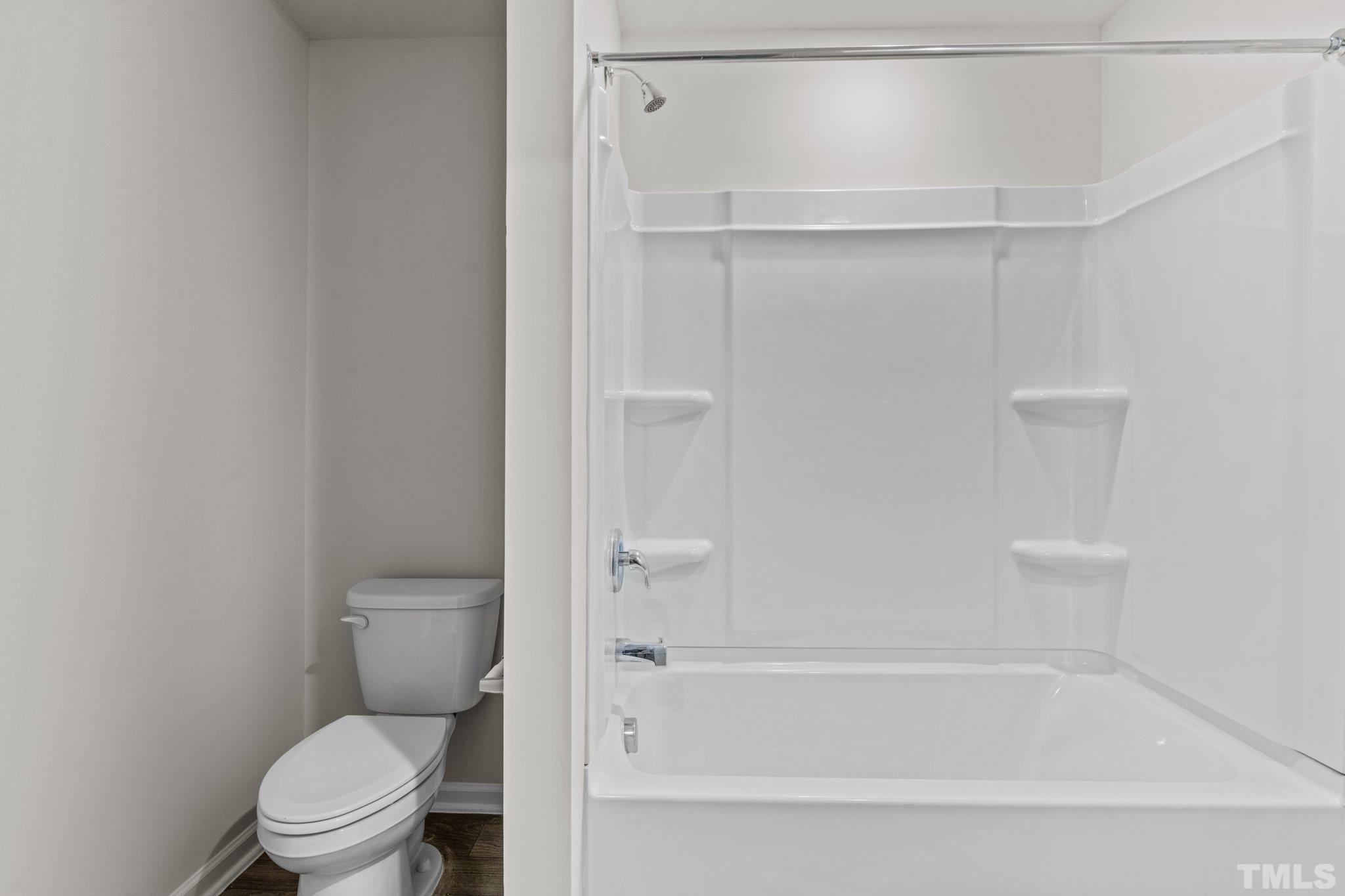 96 Somerset Drive Roxboro, NC 27573 - Photo 24 of 29 a bathroom with a toilet and a bathtub