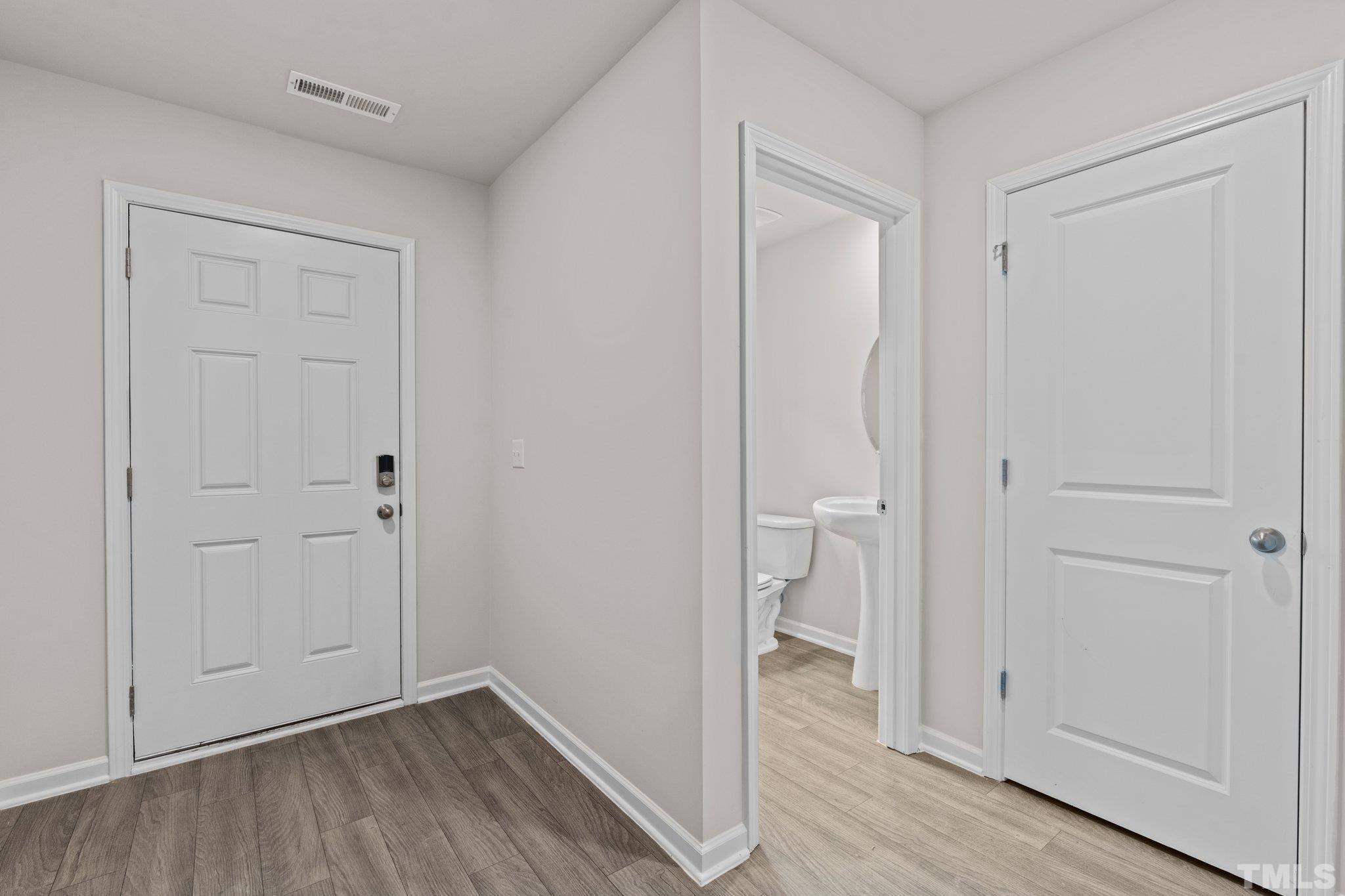 96 Somerset Drive Roxboro, NC 27573 - Photo 5 of 29 a view of room with walk in closet and wooden floor