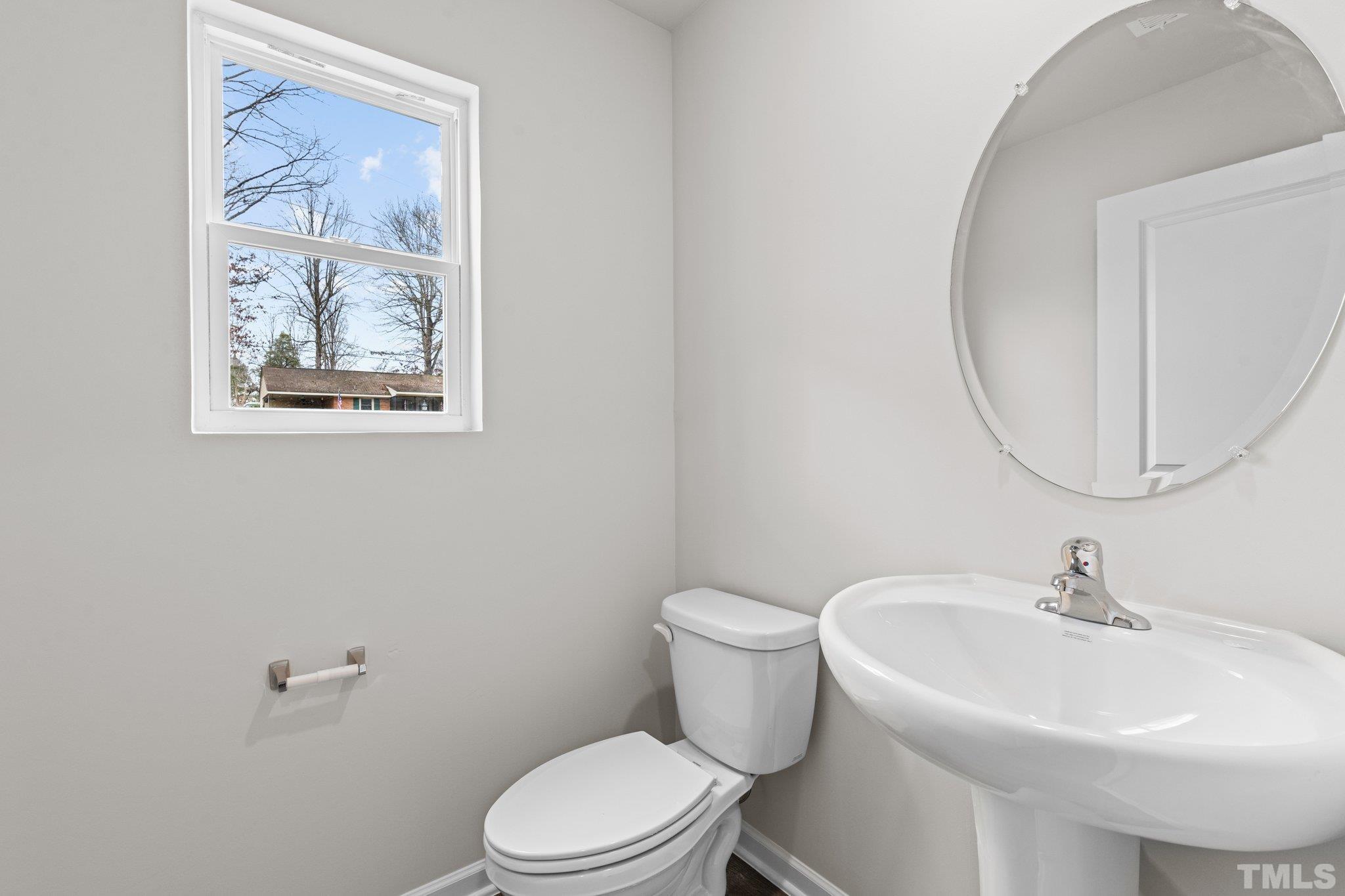 96 Somerset Drive Roxboro, NC 27573 - Photo 6 of 29 a white toilet sitting next to a bathroom sink