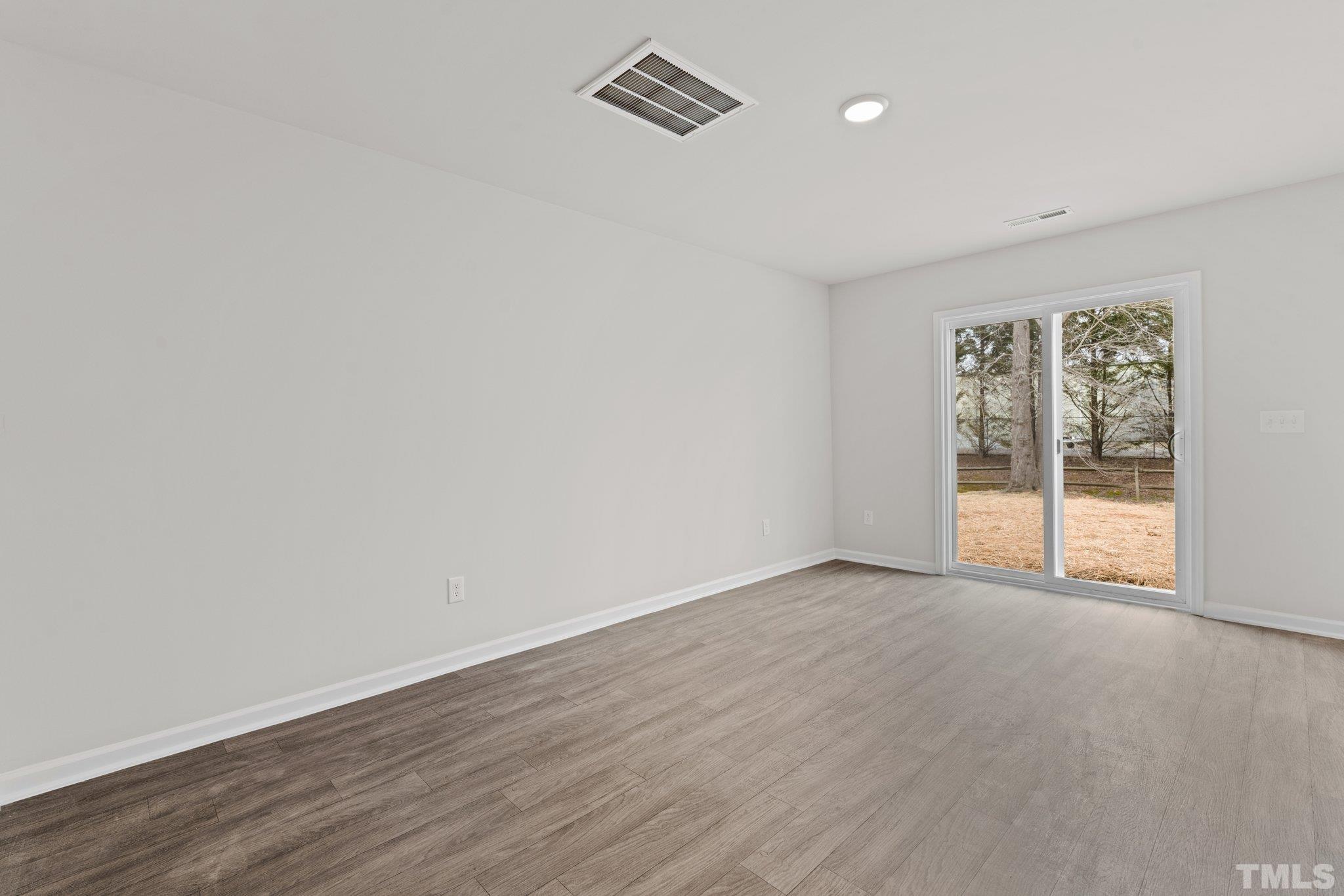 96 Somerset Drive Roxboro, NC 27573 - Photo 9 of 29 wooden floor in an empty room with a window