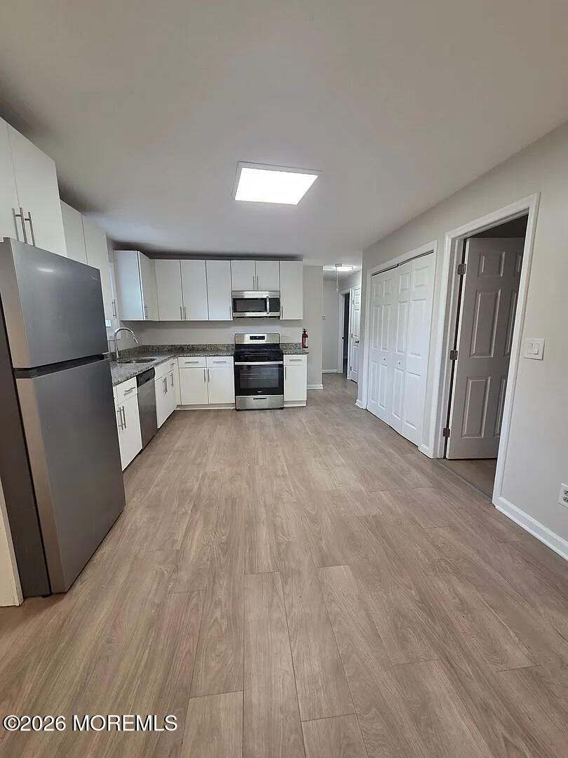 3 Freewood Street Howell, NJ 07731 - Photo 2 of 9 a kitchen with a refrigerator and a stove