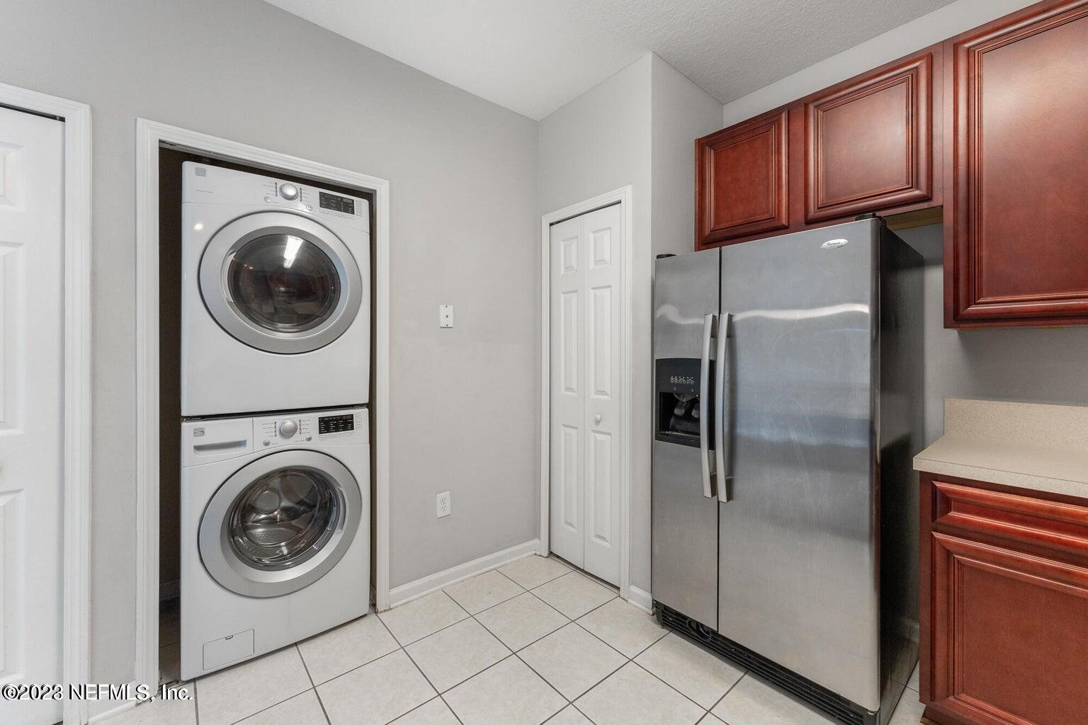8226 Green Parrot Road, Unit 308 Jacksonville, FL 32256 - Photo 11 of 31 a kitchen with a washer and dryer