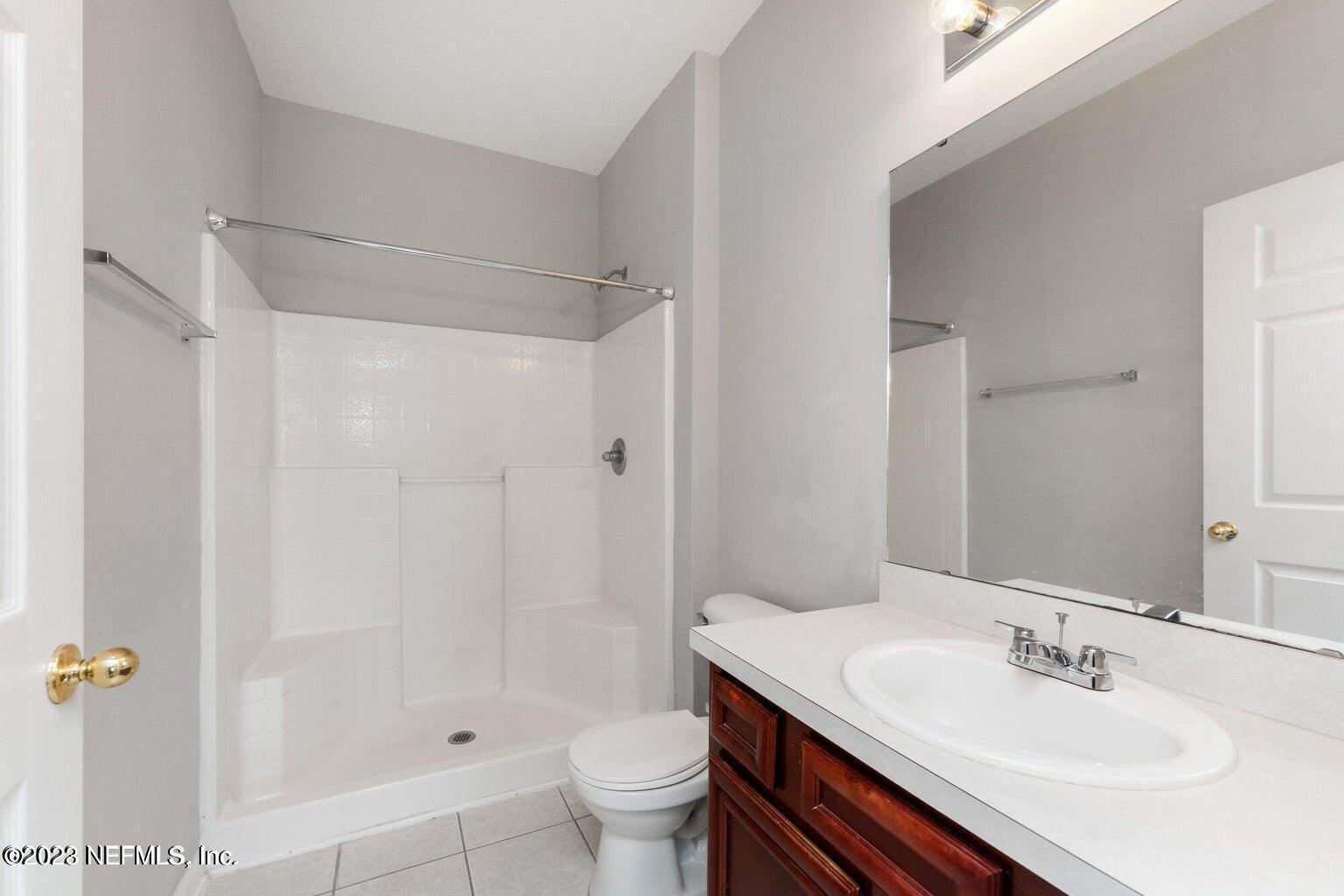 8226 Green Parrot Road, Unit 308 Jacksonville, FL 32256 - Photo 14 of 31 a bathroom with a sink toilet and shower