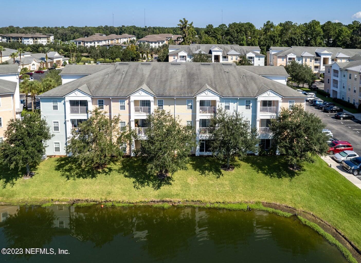 8226 Green Parrot Road, Unit 308 Jacksonville, FL 32256 - Photo 23 of 31 a aerial view of residential houses with outdoor space and lake view