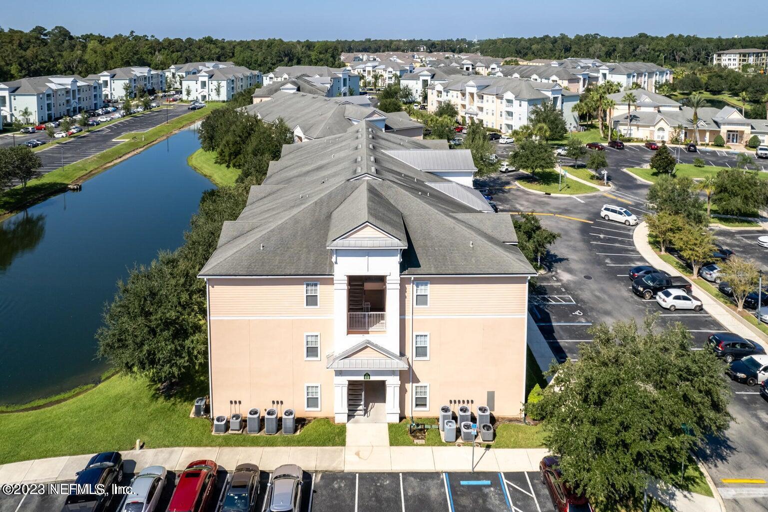 8226 Green Parrot Road, Unit 308 Jacksonville, FL 32256 - Photo 26 of 31 an aerial view of a house with a lake view