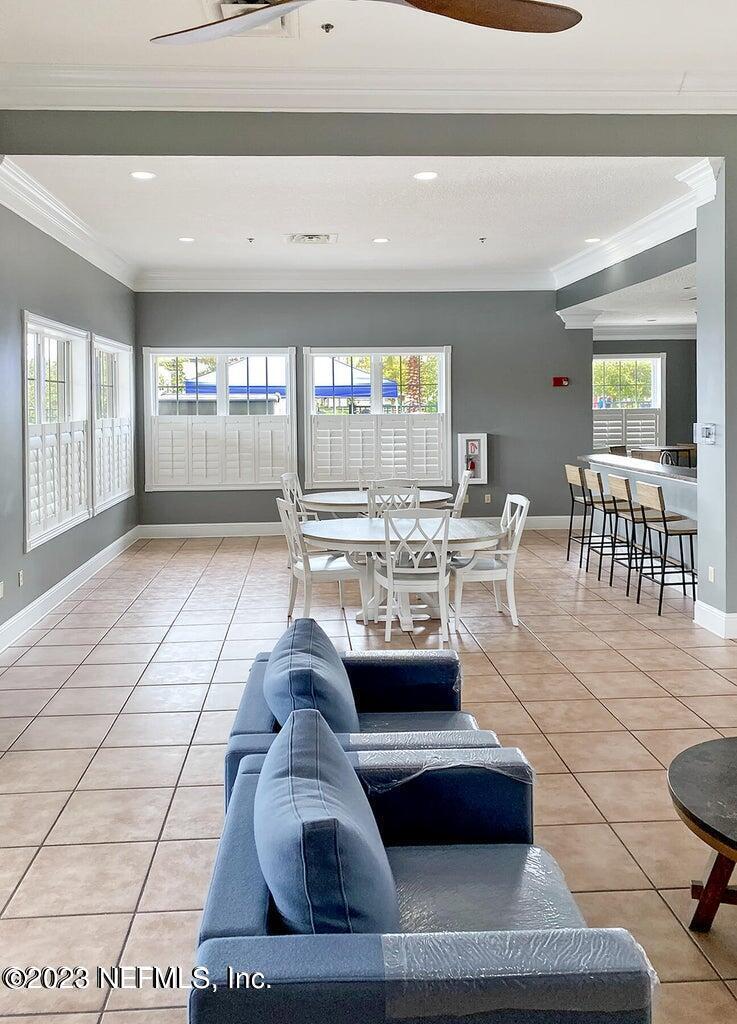 8226 Green Parrot Road, Unit 308 Jacksonville, FL 32256 - Photo 27 of 31 a living room with furniture and a flat screen tv
