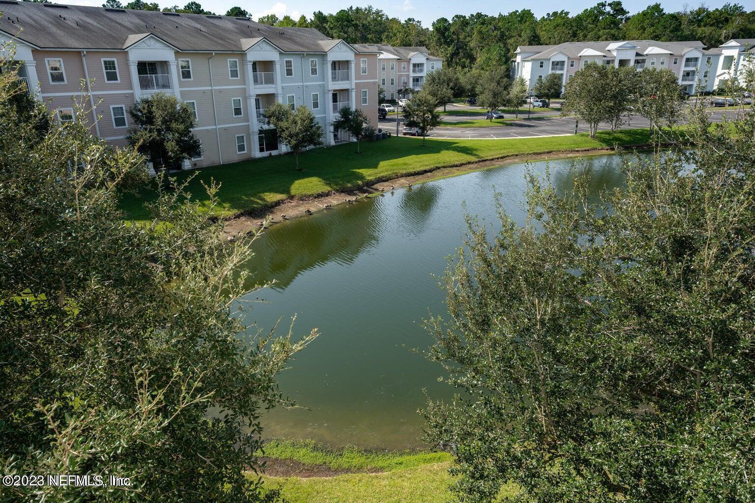 8226 Green Parrot Road, Unit 308 Jacksonville, FL 32256 - Photo 30 of 31 a view of a house with a yard and a swimming pool