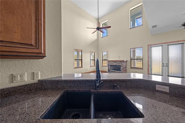 a bathroom with a granite countertop sink mirror and shower