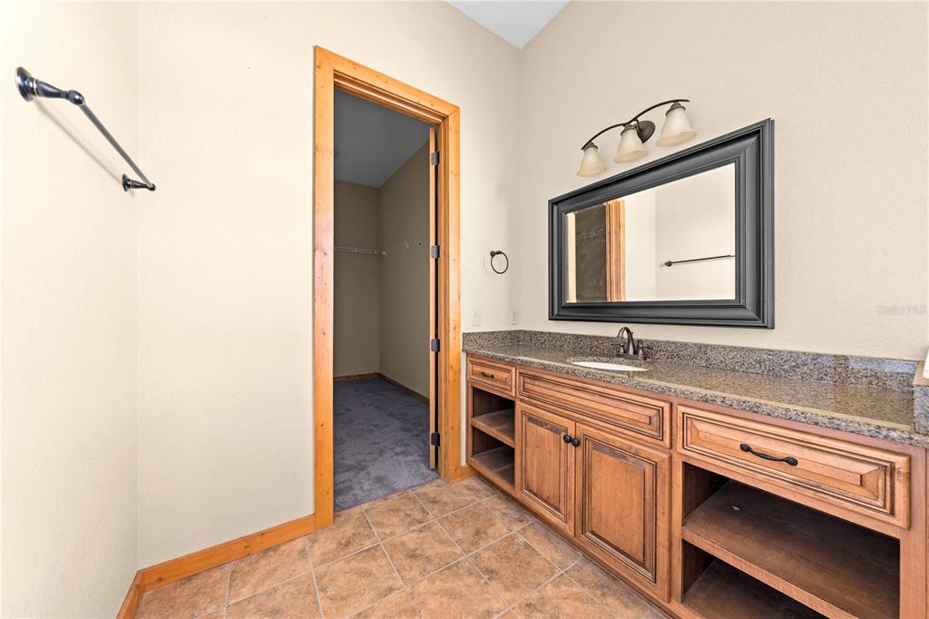 3911 Story Road St. Cloud, FL 34772 - Photo 27 of 97 a bathroom with a sink and a mirror