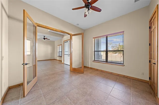 a view of a livingroom with a ceiling fan and window