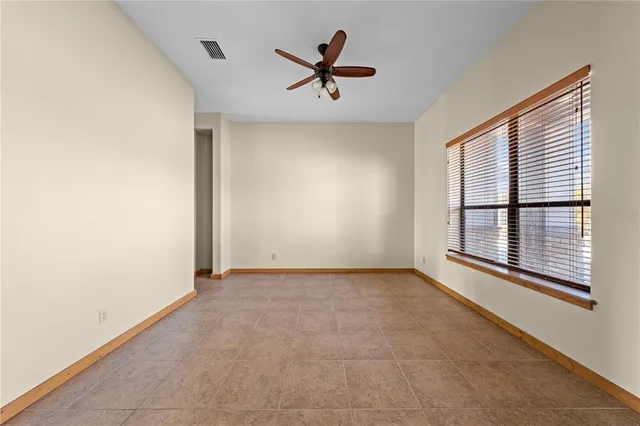 a bathroom with a granite countertop sink a toilet and a mirror