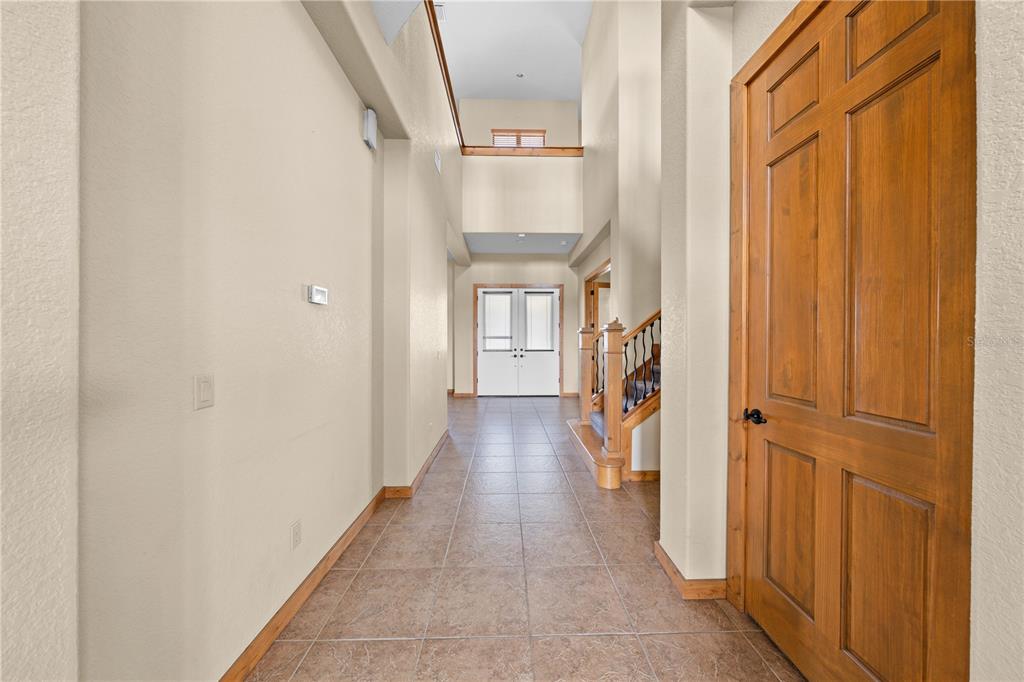 3911 Story Road St. Cloud, FL 34772 - Photo 37 of 97 a view of a hallway with wooden floor and staircase