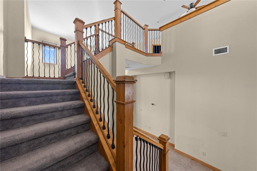 3911 Story Road St. Cloud, FL 34772 - Photo 45 of 97 a view of staircase with lots of frames on wall and a window