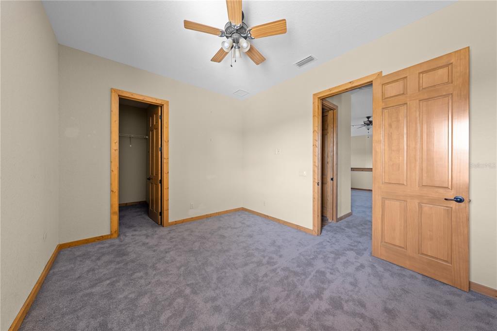 3911 Story Road St. Cloud, FL 34772 - Photo 56 of 97 an empty room with closet and a ceiling fan