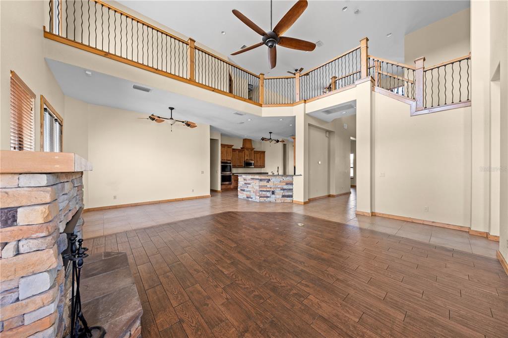 3911 Story Road St. Cloud, FL 34772 - Photo 9 of 97 a view of a room with wooden floor and staircase