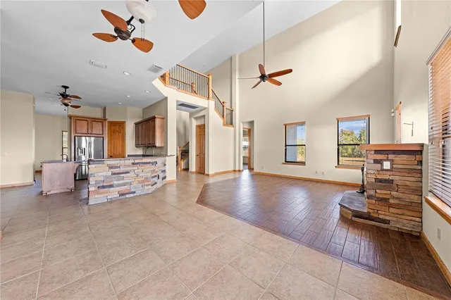 a kitchen with stainless steel appliances granite countertop a stove top oven a sink dishwasher and cabinets with wooden floor