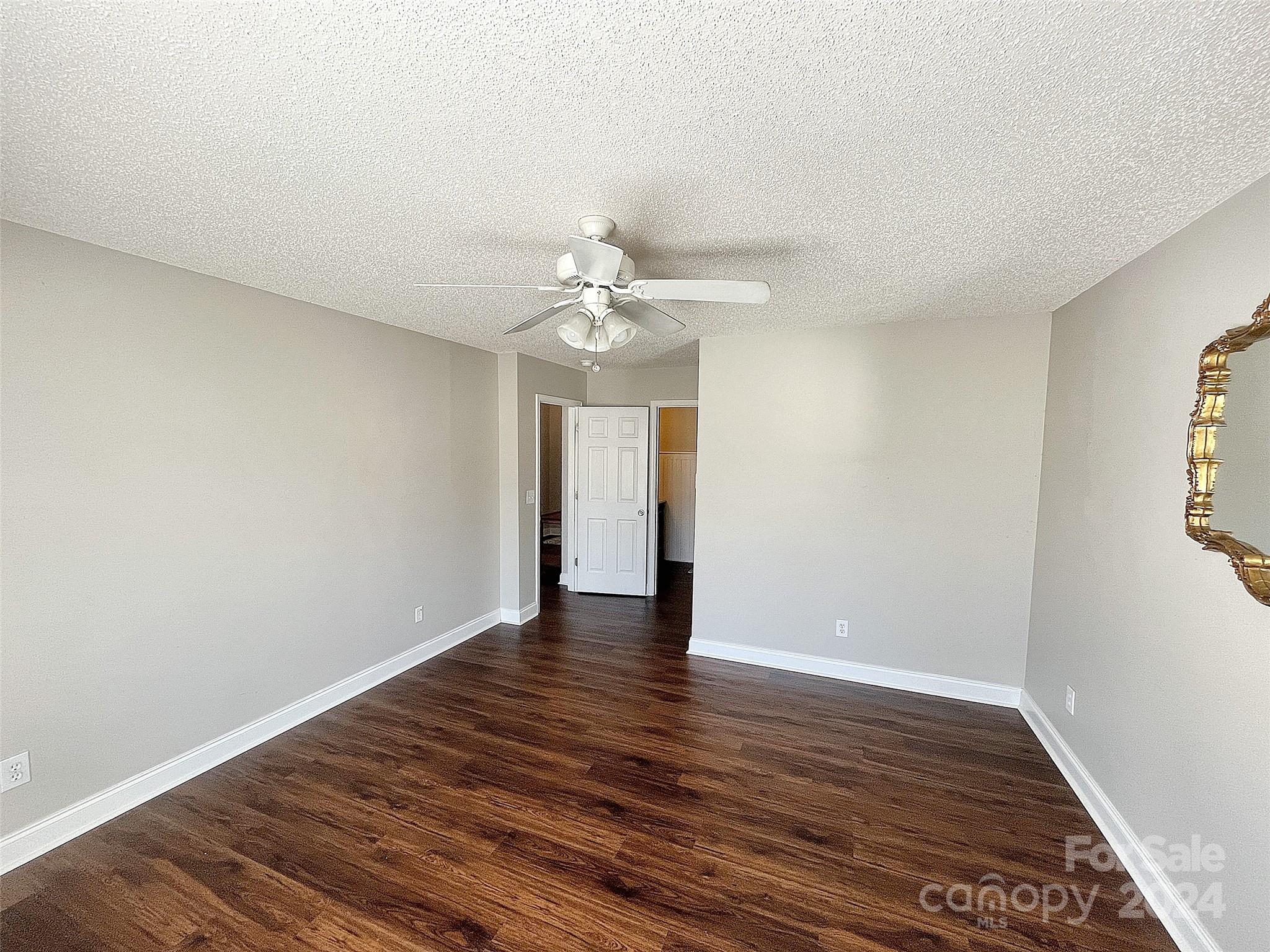 251 Maple Ridge Circle Salisbury, NC 28147 - Photo 9 of 20 a view of an empty room with wooden floor and a window