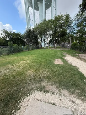 a view of a garden with a building in the background