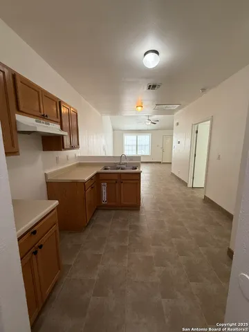 a kitchen with stainless steel appliances a stove a sink and a refrigerator