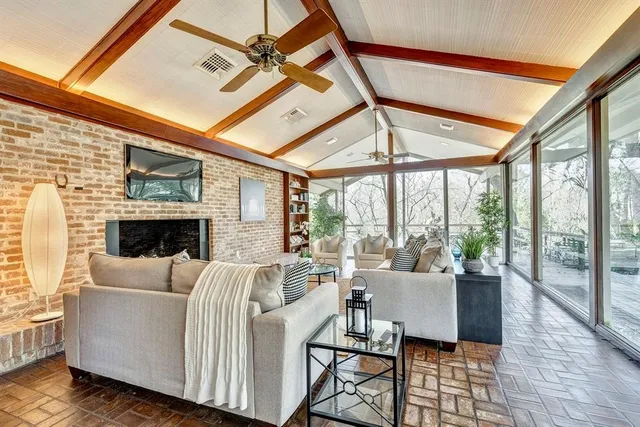 a living room with furniture a fireplace and wooden floor
