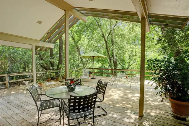 a view of a patio with table and chairs and potted plants