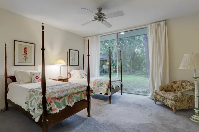 a bedroom with bed and glass door