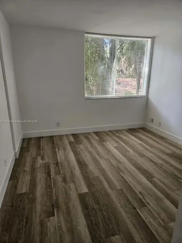 a view of wooden floor in an empty room