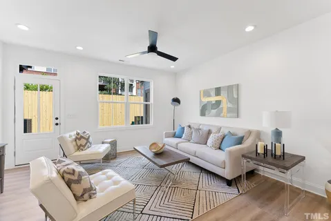 a view of a dining room with furniture and a chandelier