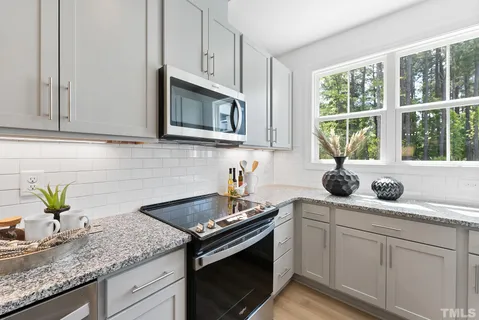 a kitchen with granite countertop a sink and a window