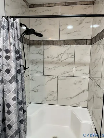a bathroom with a bathtub and shower