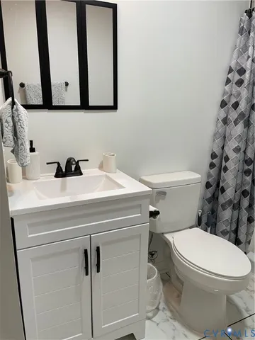 a bathroom with a sink toilet and mirror