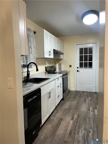 a kitchen with a sink stove and cabinets
