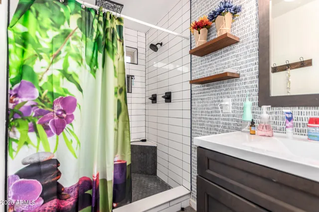 a bathroom with a sink toilet and shower