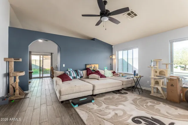 a bedroom with furniture and a large window