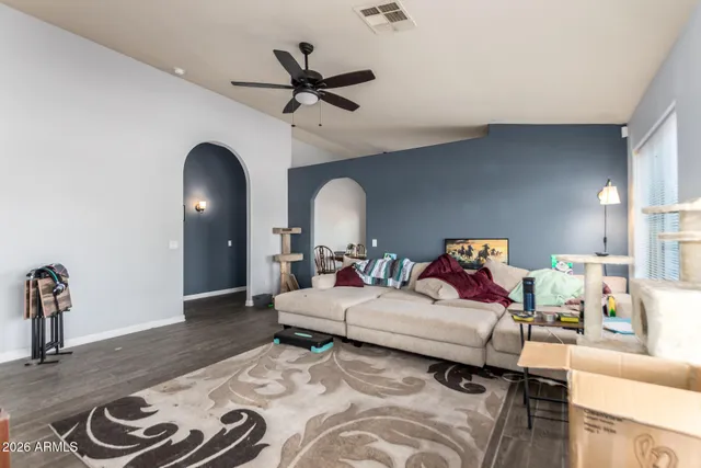 a living room with furniture and a wooden floor