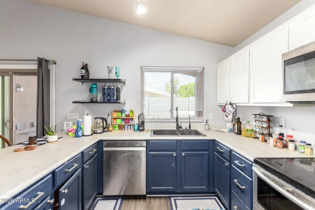 a kitchen with a sink cabinets and window
