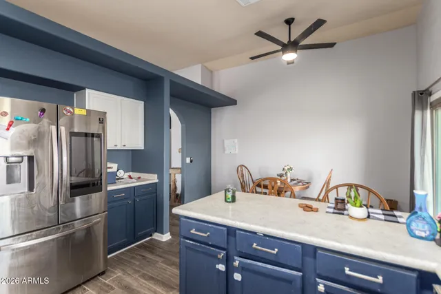 a kitchen with a refrigerator a sink and cabinets