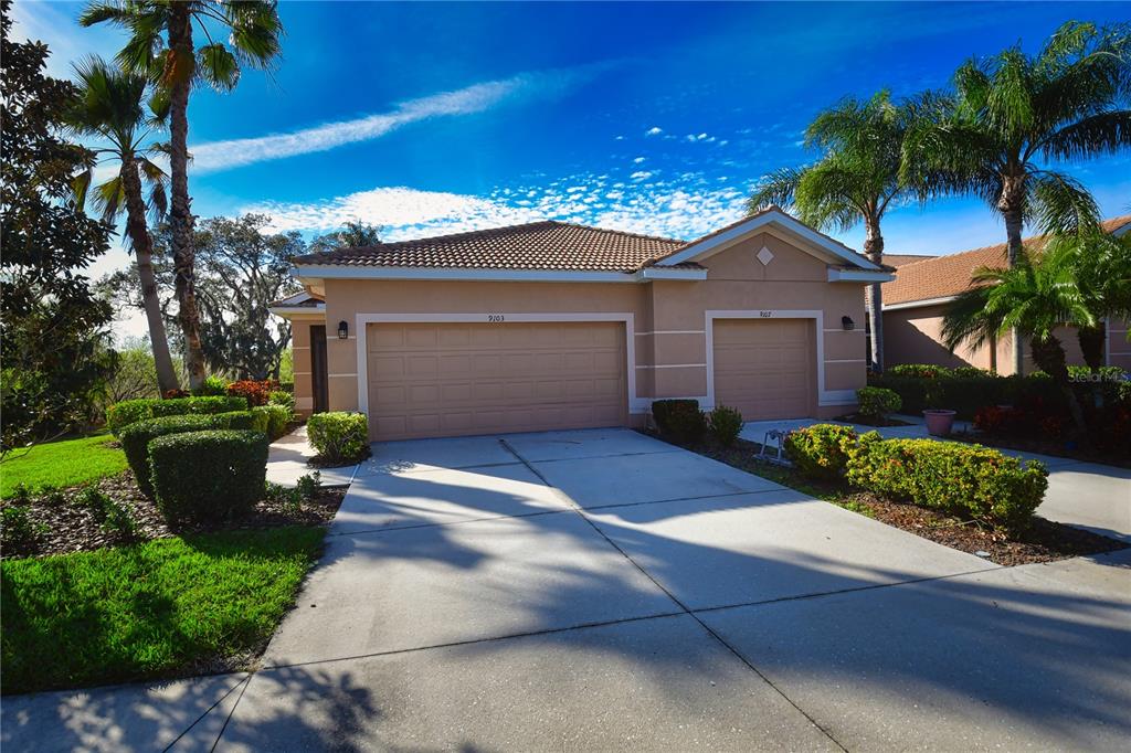 a front view of a house with a yard and garage