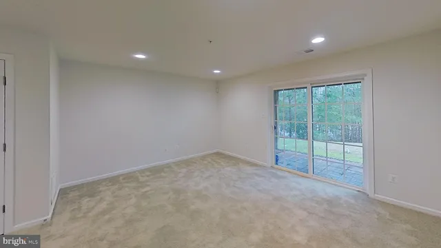 a view of an empty room with glass door