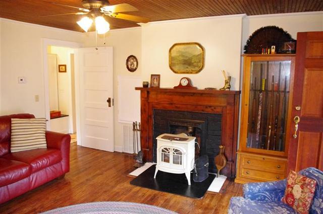 Living room with fireplace and hardwood floors. 